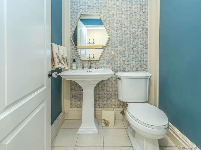 23 Ivy Way Port Washington, NY 11050 - Photo 20 of 47 a white toilet sitting next to a bathroom sink