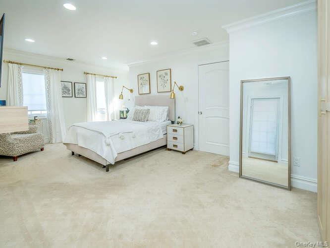 23 Ivy Way Port Washington, NY 11050 - Photo 22 of 47 a spacious bedroom with a bed and a couch