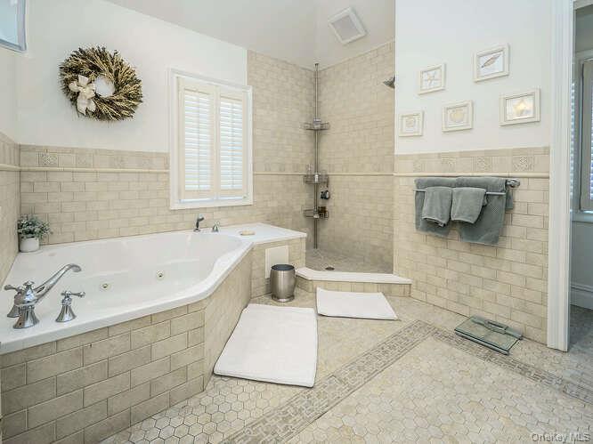 23 Ivy Way Port Washington, NY 11050 - Photo 29 of 47 a bathroom with a tub a sink and a shower