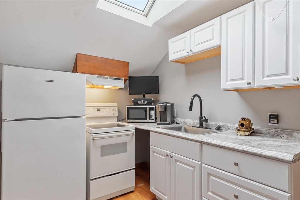 241 Reservoir Road Lunenburg, MA 01462 - Photo 35 of 40 a kitchen with stainless steel appliances white cabinets and a refrigerator