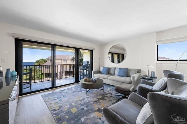 a living room with furniture and a floor to ceiling window
