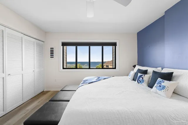 a bedroom with a large bed and a large window