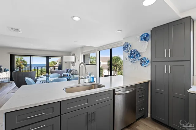 a kitchen with kitchen island a sink appliances and cabinets