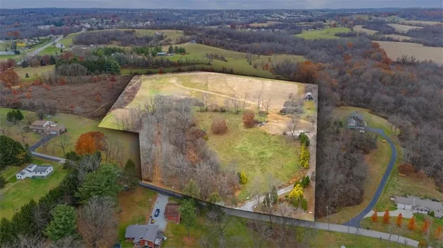 a view of a house with a yard and mountains
