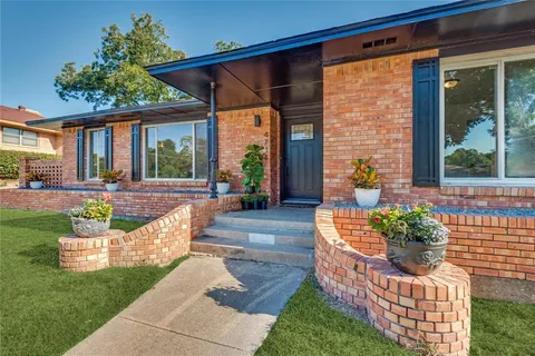 a view of a house with a porch and furniture