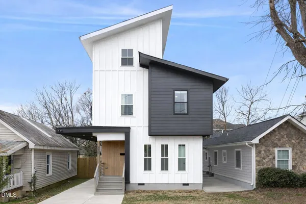 a large kitchen with stainless steel appliances kitchen island granite countertop a stove a sink and a wooden floors