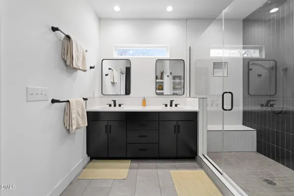 a living room with a floor to ceiling window and wooden floor