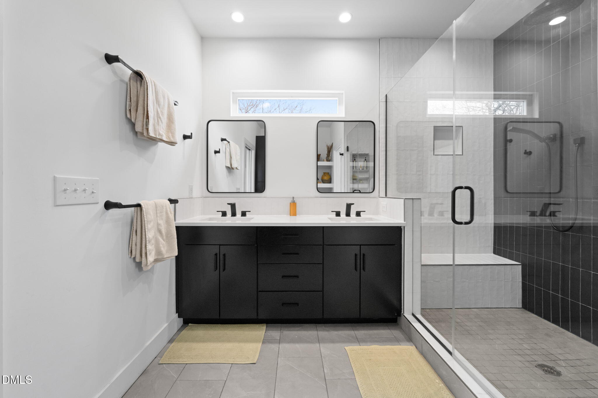 320 South Tarboro Street Raleigh, NC 27610 - Photo 20 of 54 a bathroom with a double vanity sink and mirror