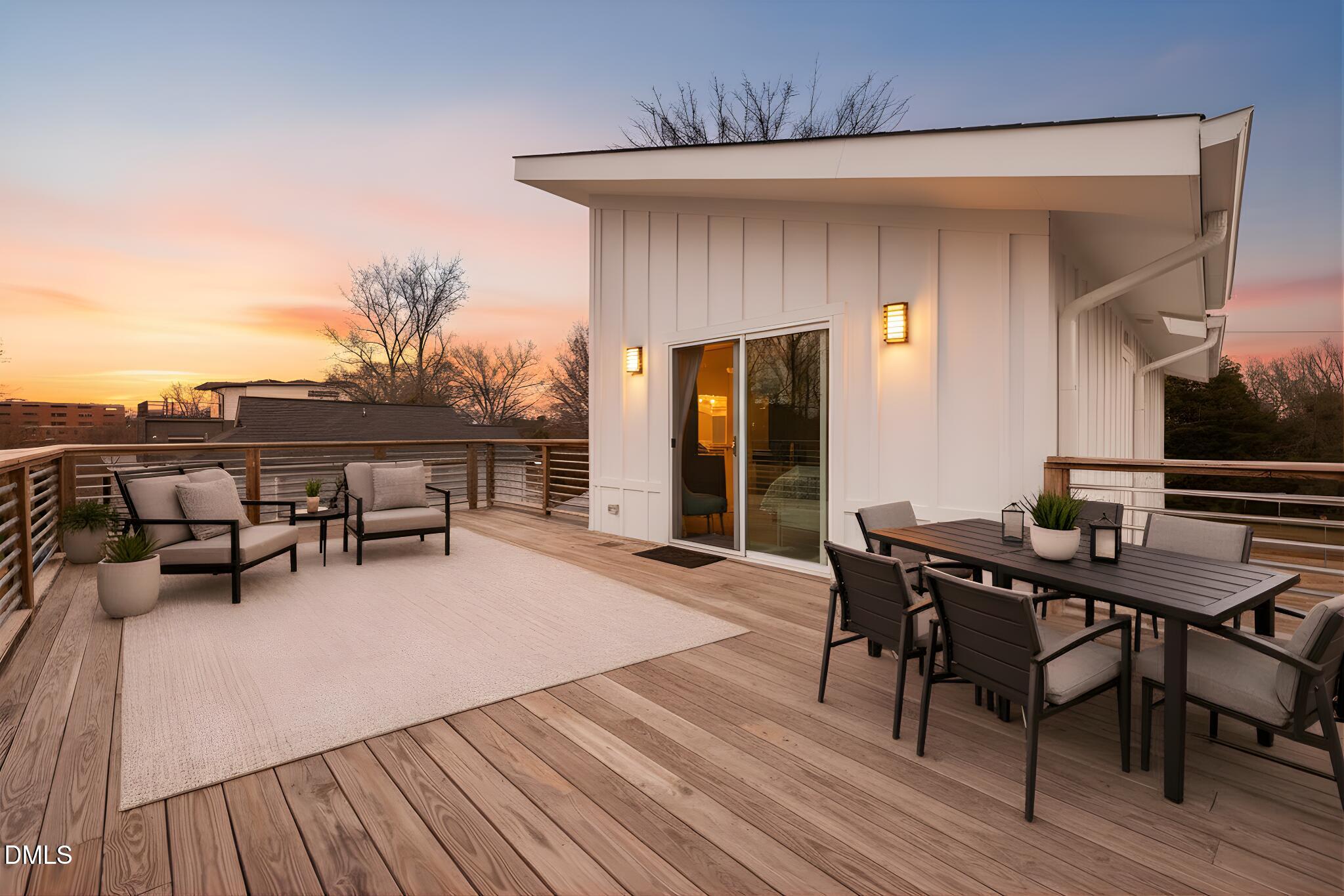 320 South Tarboro Street Raleigh, NC 27610 - Photo 2 of 54 a view of a patio with table and chairs and potted plants with wooden floor and fence
