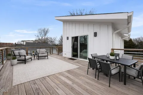 a terrace with outdoor seating and wooden floor