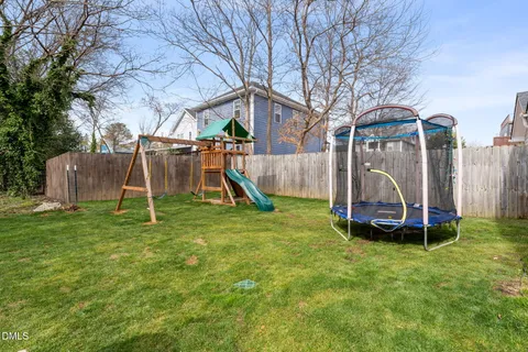 a park view with a bench and a slide