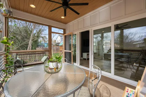 a living room with furniture and large windows
