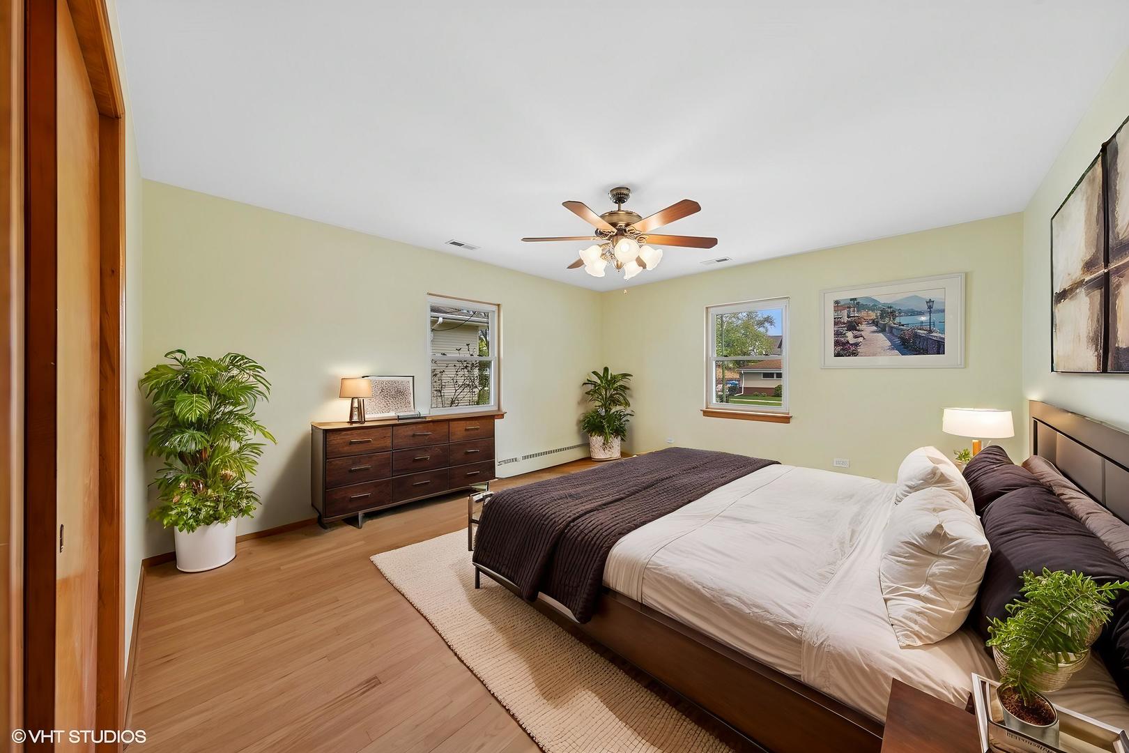 7010 West Devon Avenue Chicago, IL 60631 - Photo 12 of 51 a bedroom with a bed and a potted plant