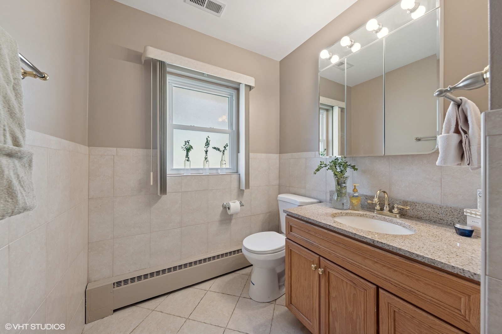 7010 West Devon Avenue Chicago, IL 60631 - Photo 18 of 51 a bathroom with a granite countertop sink toilet and shower