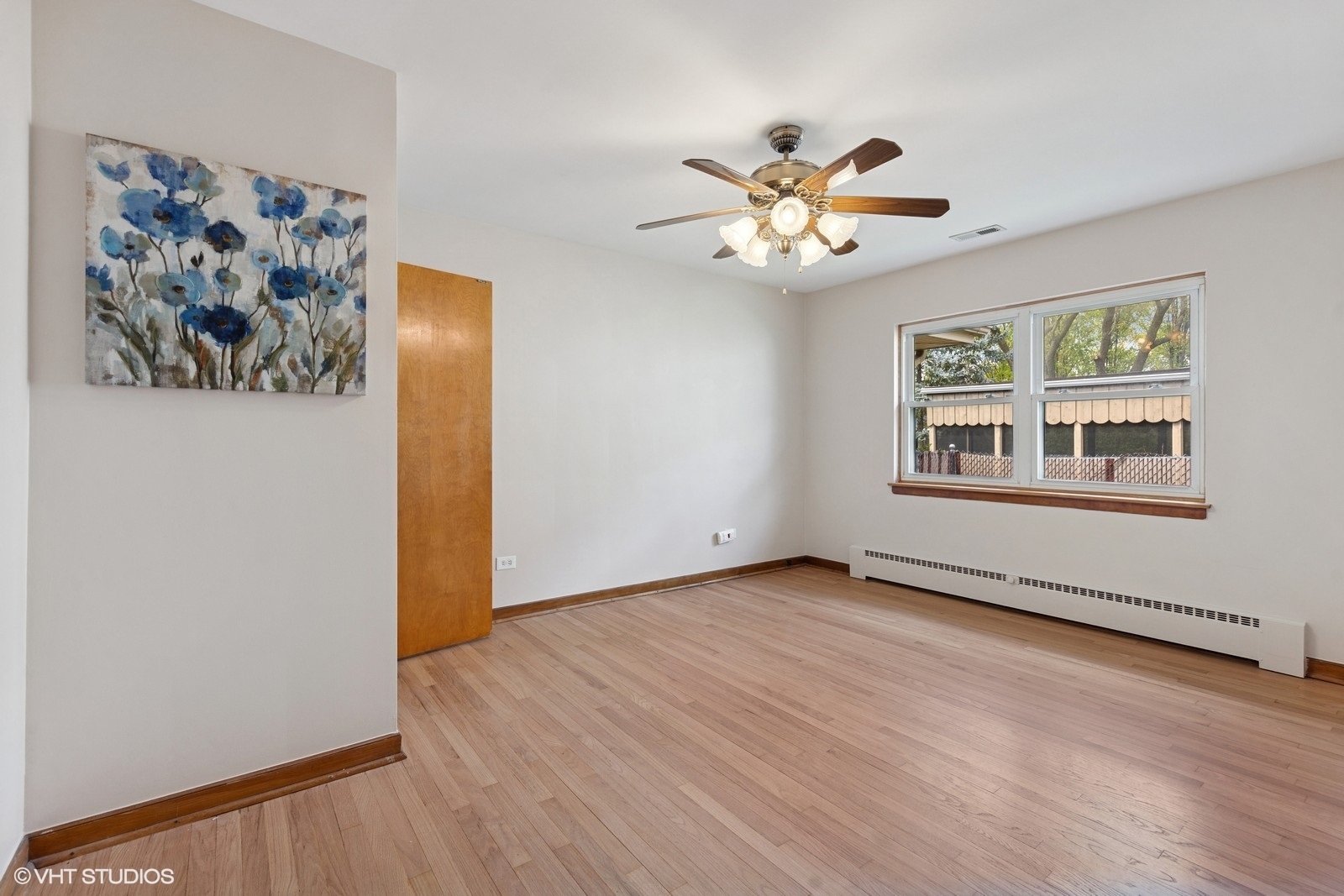 7010 West Devon Avenue Chicago, IL 60631 - Photo 19 of 51 a view of an empty room with window and wooden floor
