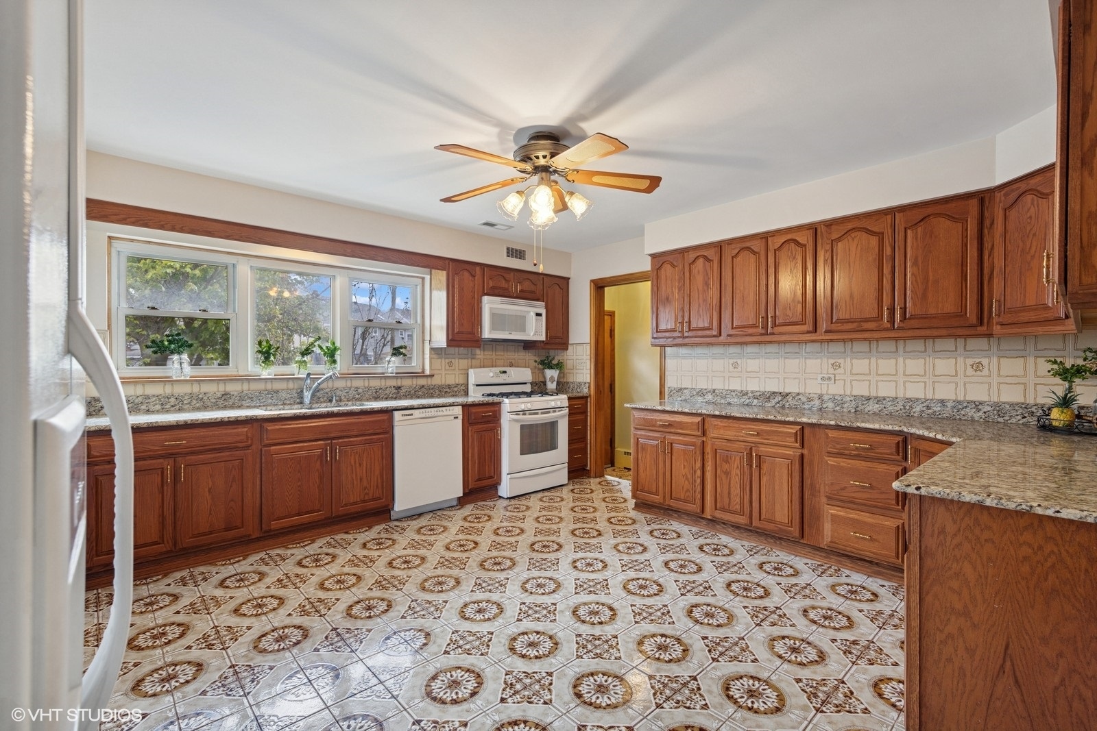 7010 West Devon Avenue Chicago, IL 60631 - Photo 21 of 51 a kitchen with stainless steel appliances granite countertop a stove sink and cabinets