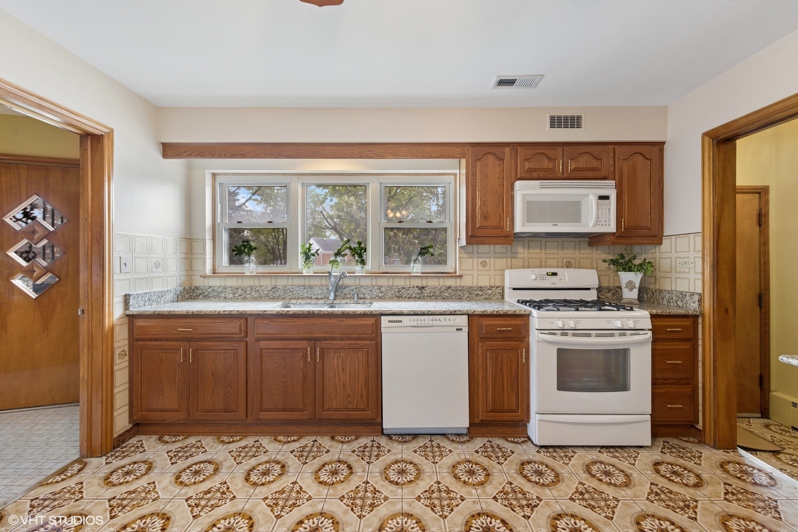 7010 West Devon Avenue Chicago, IL 60631 - Photo 22 of 51 a kitchen with stainless steel appliances granite countertop a sink and wooden cabinets