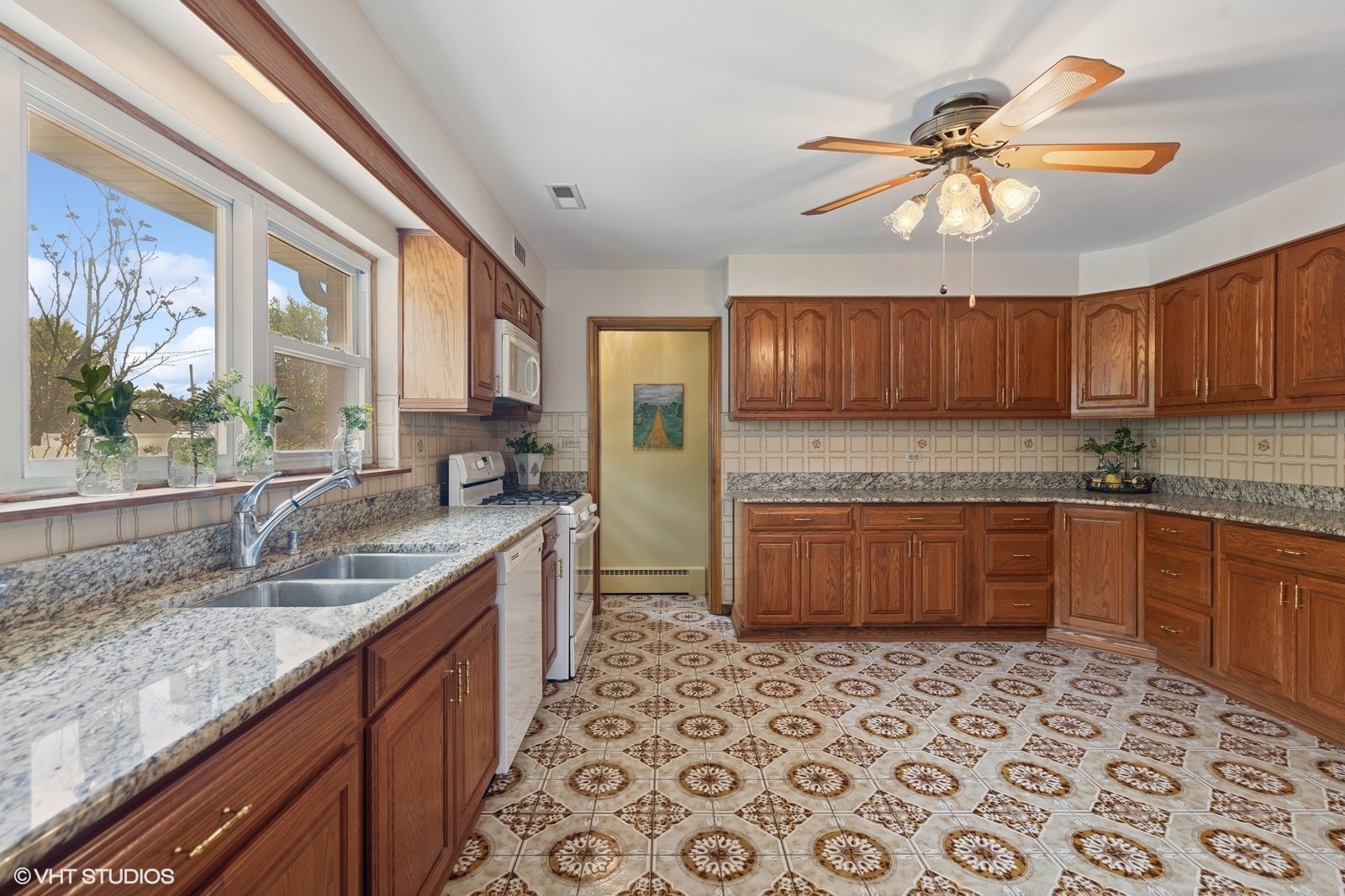 7010 West Devon Avenue Chicago, IL 60631 - Photo 23 of 51 a kitchen with stainless steel appliances granite countertop a sink stove and cabinets