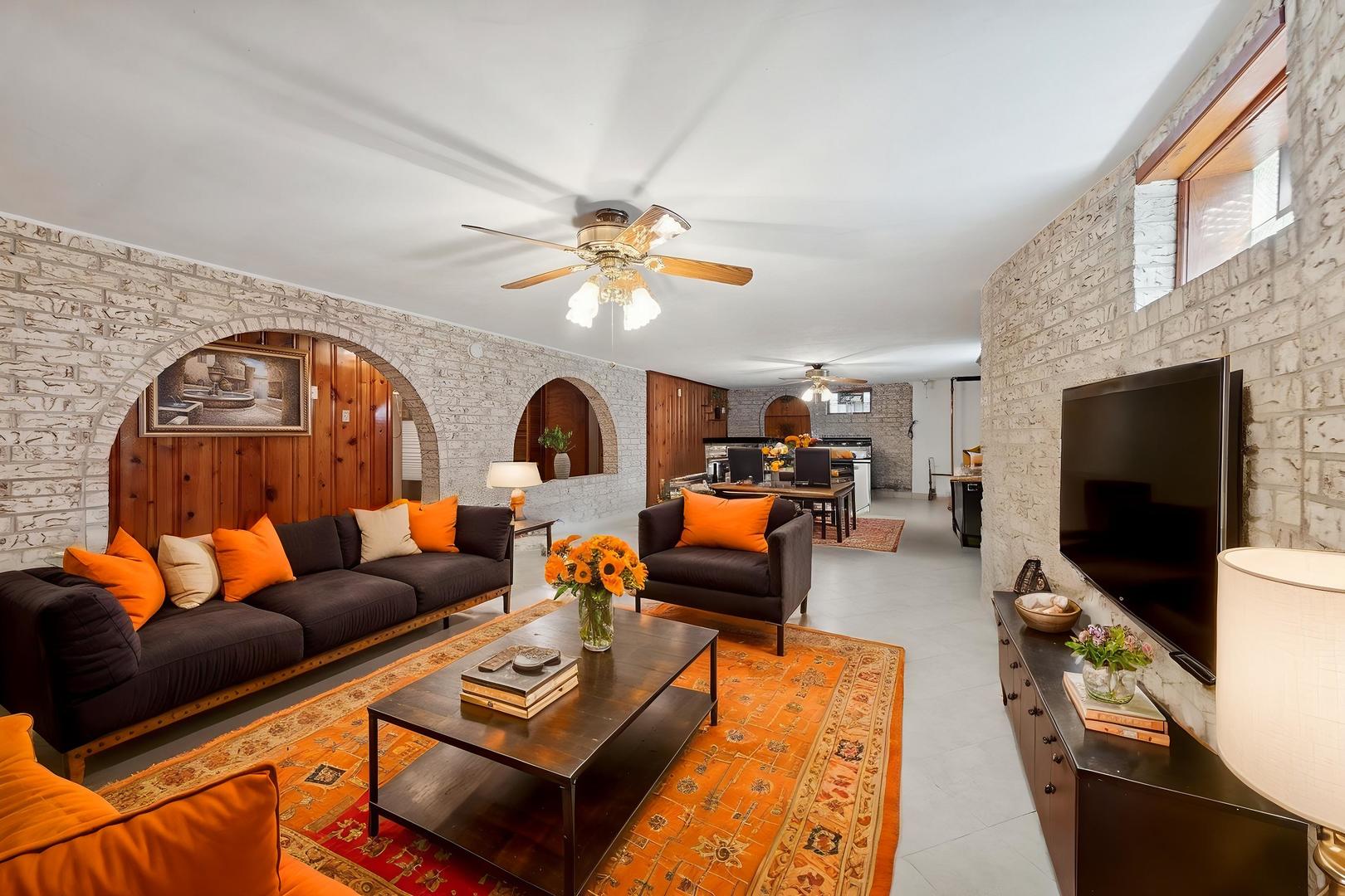 7010 West Devon Avenue Chicago, IL 60631 - Photo 32 of 51 a living room with furniture and a flat screen tv