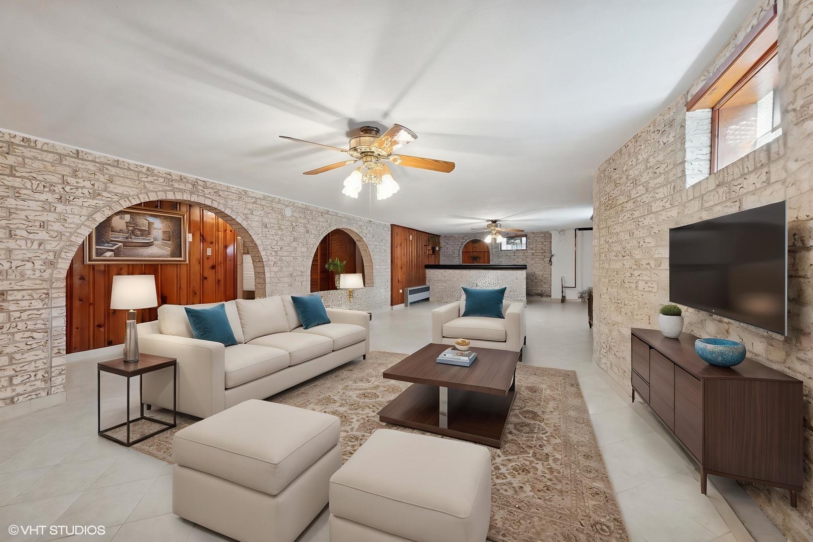 7010 West Devon Avenue Chicago, IL 60631 - Photo 33 of 51 a living room with furniture a flat screen tv and a fireplace