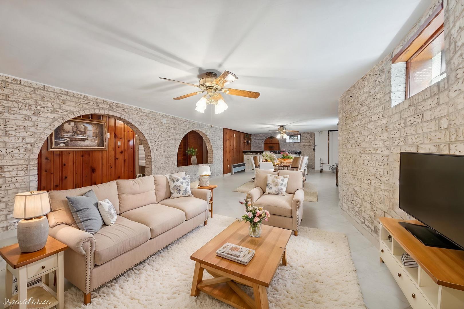 7010 West Devon Avenue Chicago, IL 60631 - Photo 34 of 51 a living room with furniture a flat screen tv and a fireplace