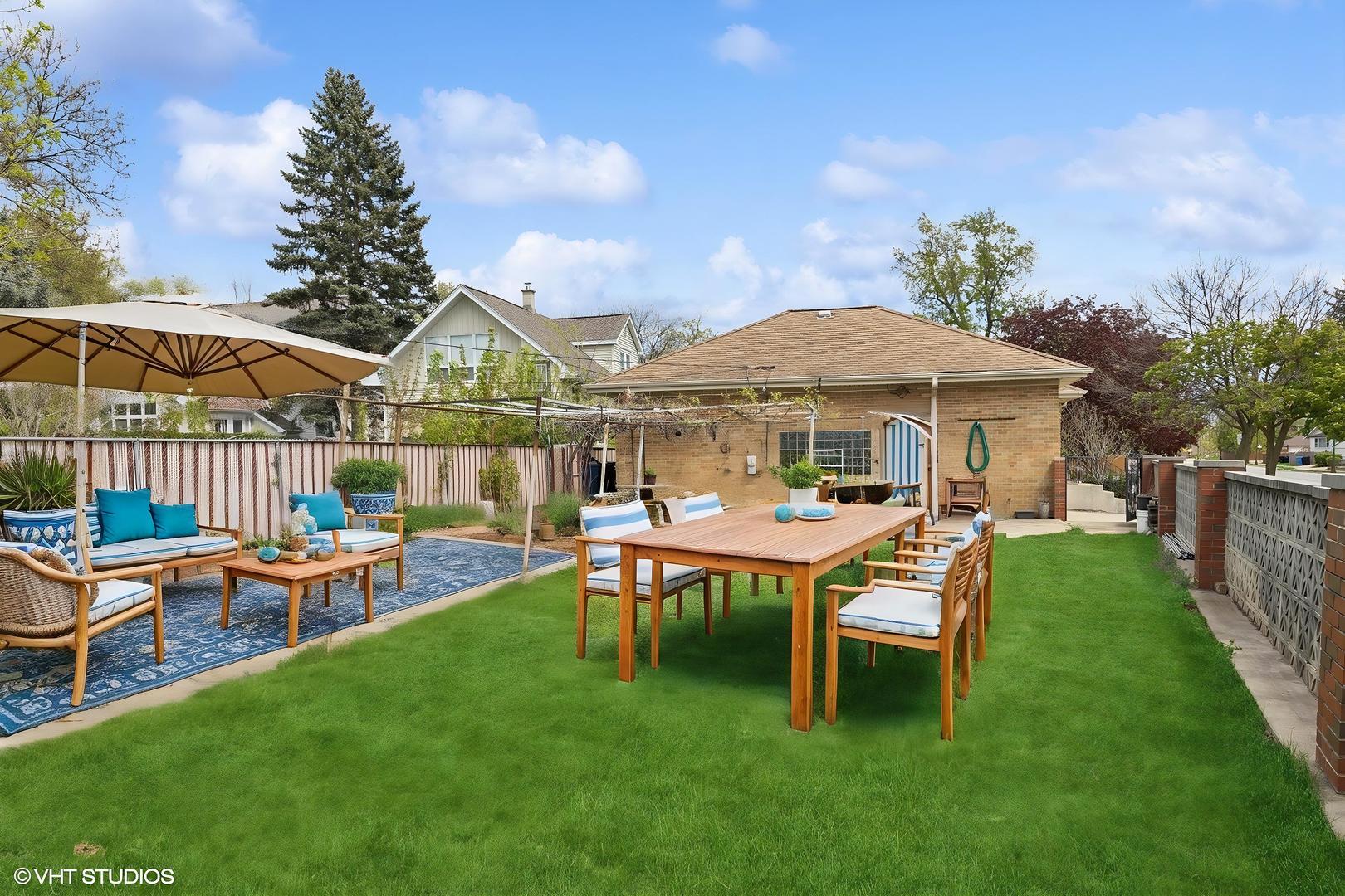 7010 West Devon Avenue Chicago, IL 60631 - Photo 43 of 51 a view of a house with backyard porch and sitting area