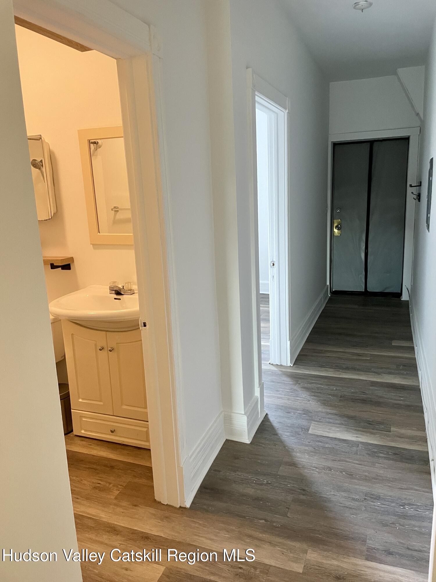 426 Warren Street, Unit 3 Hudson, NY 12534 - Photo 10 of 13 a view of a hallway with wooden floor and a sink