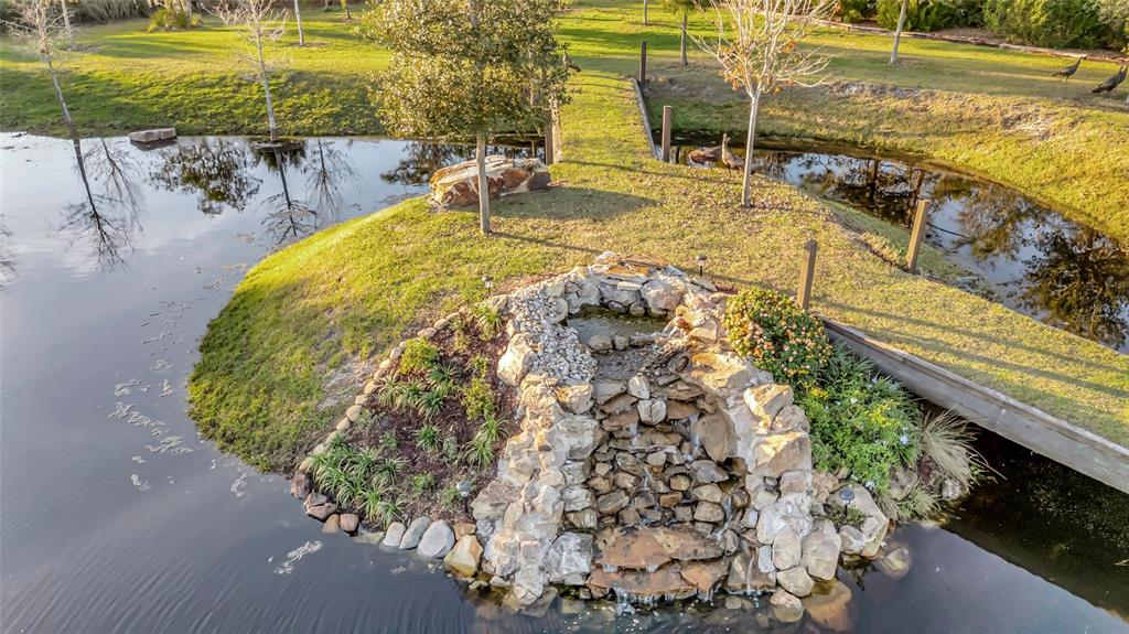 7330 Crabgrass Road St. Cloud, FL 34773 - Photo 32 of 60 a view of a swimming pool with a lawn chairs under an umbrella