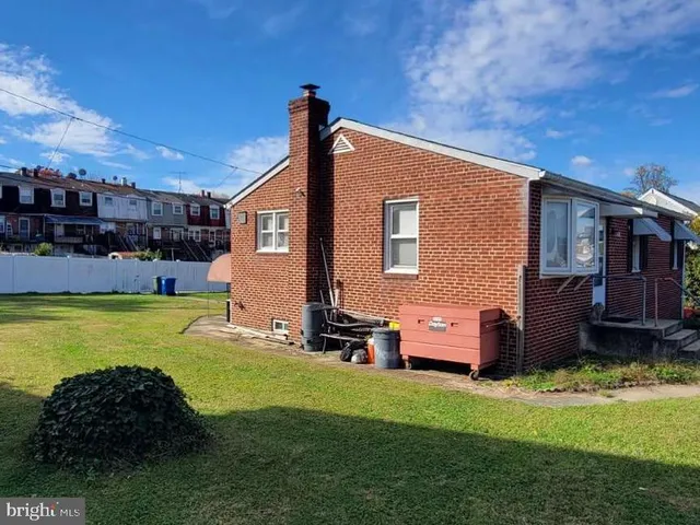 a front view of a house with a yard table and chairs