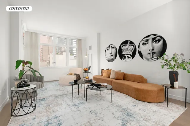 a living room with furniture a rug and a window