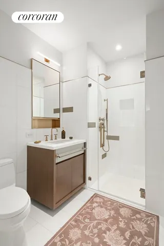a bathroom with a sink toilet and shower