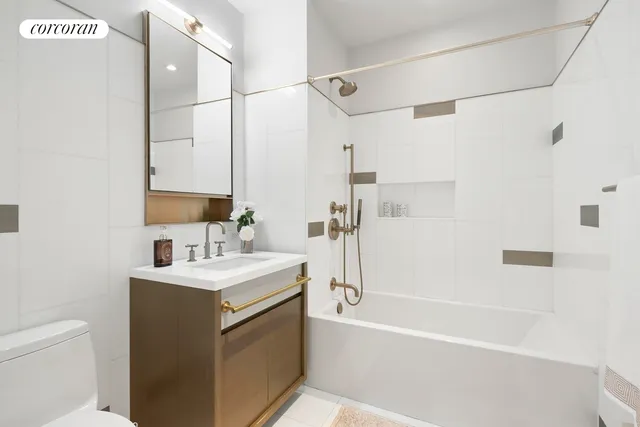 a bathroom with a sink toilet vanity and shower