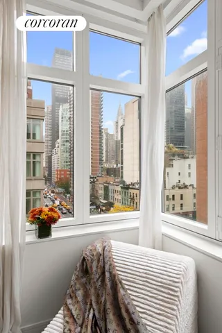 a bedroom with furniture and large windows