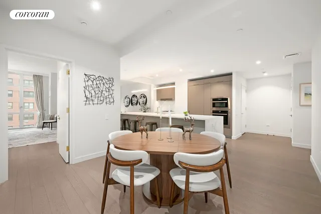 a dining room with furniture and wooden floor