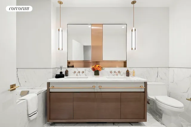 a bathroom with a sink a toilet and a mirror