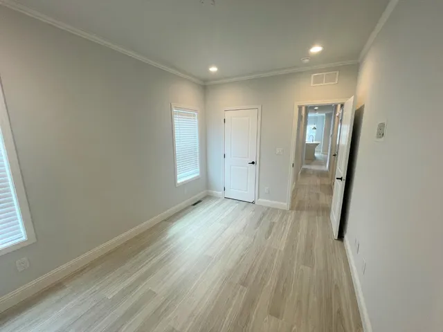 a view of a hallway with wooden floor
