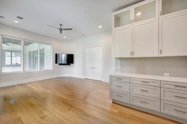 a view of a kitchen with wooden cabinet