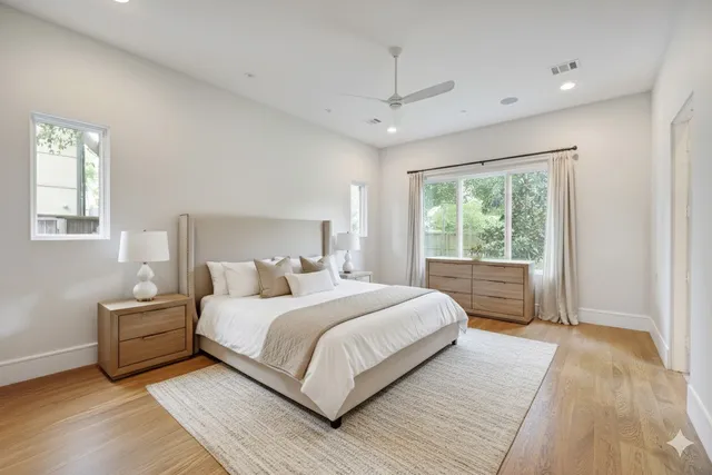 a bedroom with a large bed and a window