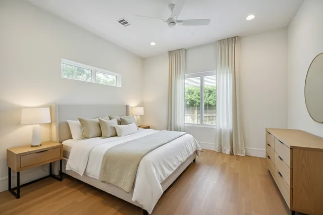 a bedroom with a large bed and a window