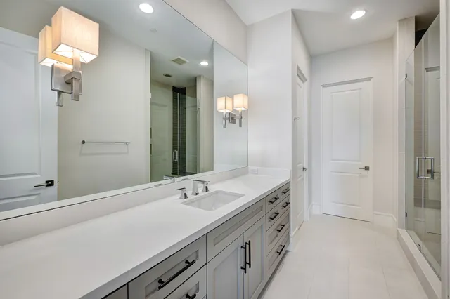 a bathroom with a double vanity sink and a mirror