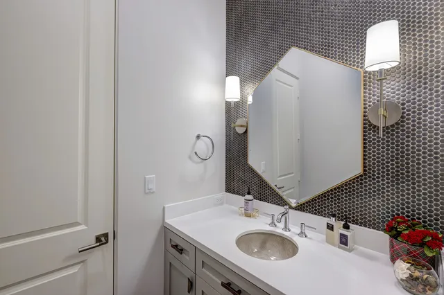 a bathroom with a sink vanity and mirror