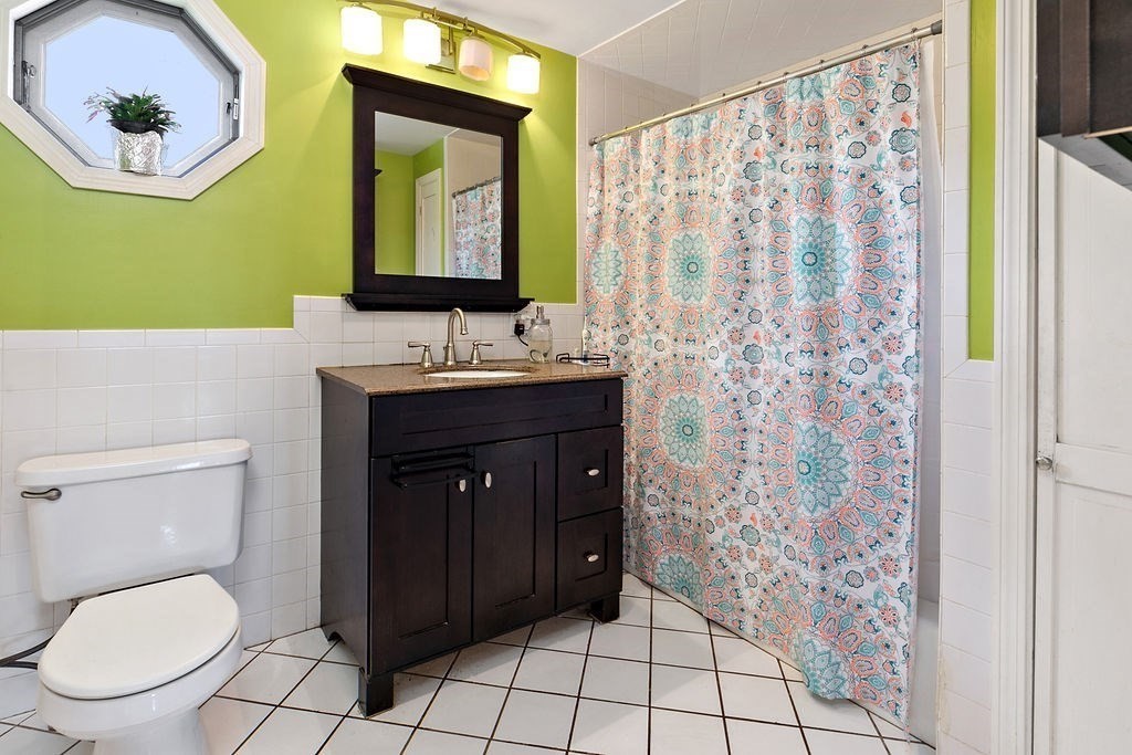 524 Merrimack Street Methuen, MA 01844 - Photo 13 of 34 a bathroom with a toilet a sink and a mirror