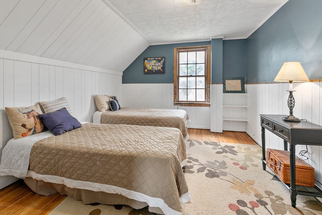 524 Merrimack Street Methuen, MA 01844 - Photo 14 of 34 a bedroom with a bed and a lamp