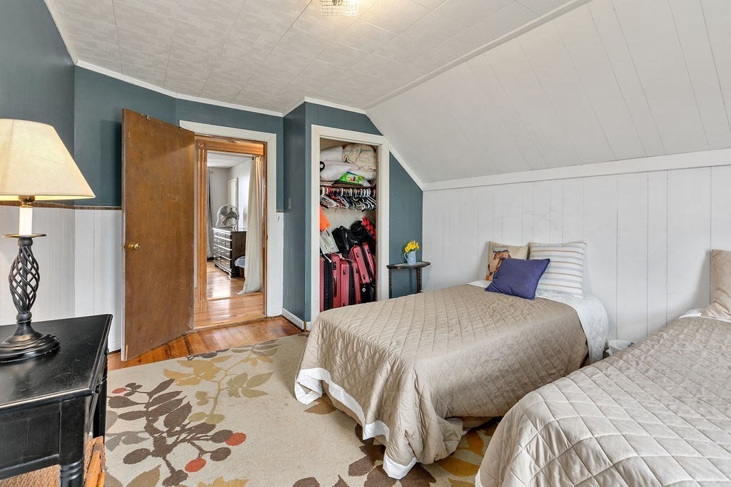 524 Merrimack Street Methuen, MA 01844 - Photo 15 of 34 a bedroom with two beds and a lamp on dresser