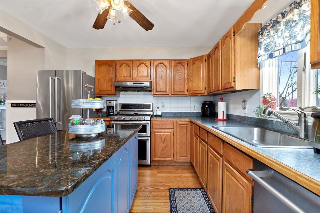 524 Merrimack Street Methuen, MA 01844 - Photo 5 of 34 a kitchen with stainless steel appliances granite countertop a sink a stove and a refrigerator