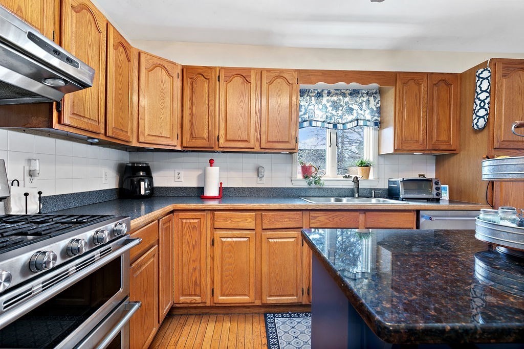 524 Merrimack Street Methuen, MA 01844 - Photo 7 of 34 a kitchen with granite countertop a stove a sink and a granite counter tops