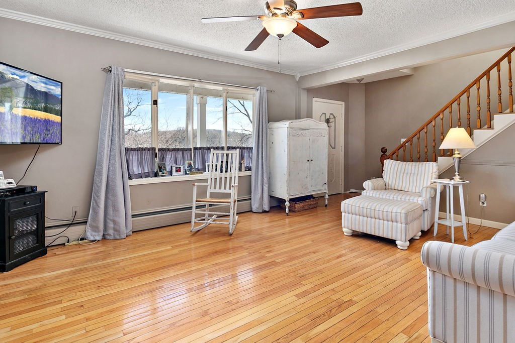 524 Merrimack Street Methuen, MA 01844 - Photo 10 of 34 a living room with furniture and a wooden floor