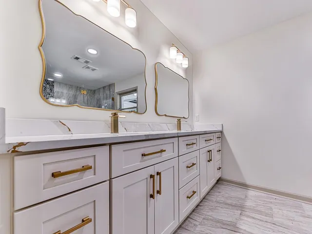 a bathroom with a double vanity sink and a mirror