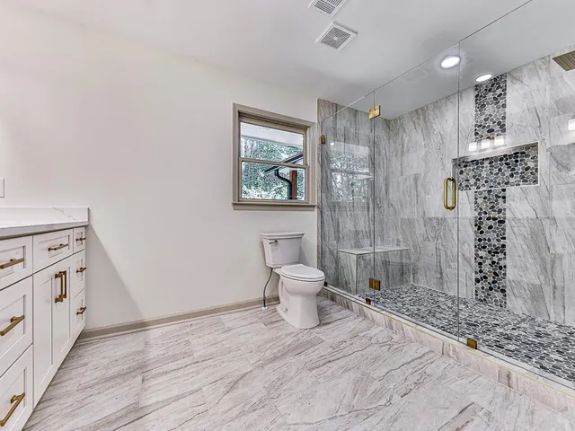 a bathroom with a toilet sink and shower