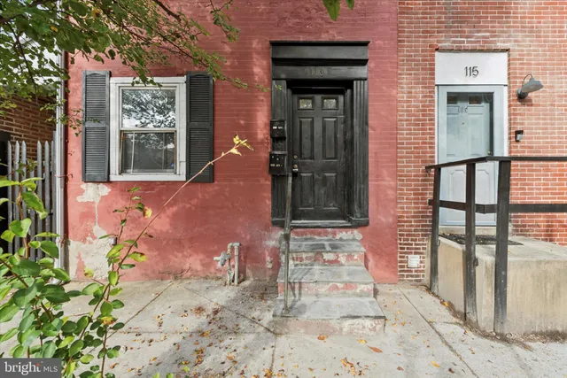 an empty room with windows and cabinet